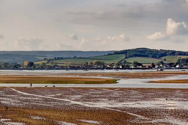 People walk along the river bottom Exe. Low tide. Exmouth. Devon. England